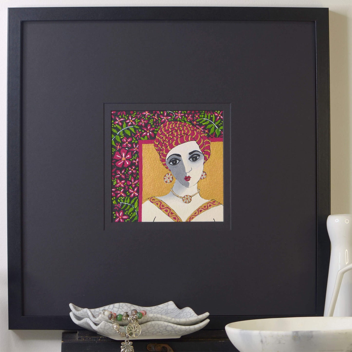 Small, original gouache painting of spiritual feminine power and beauty with golden detail by Ella Que Artist in black single mat