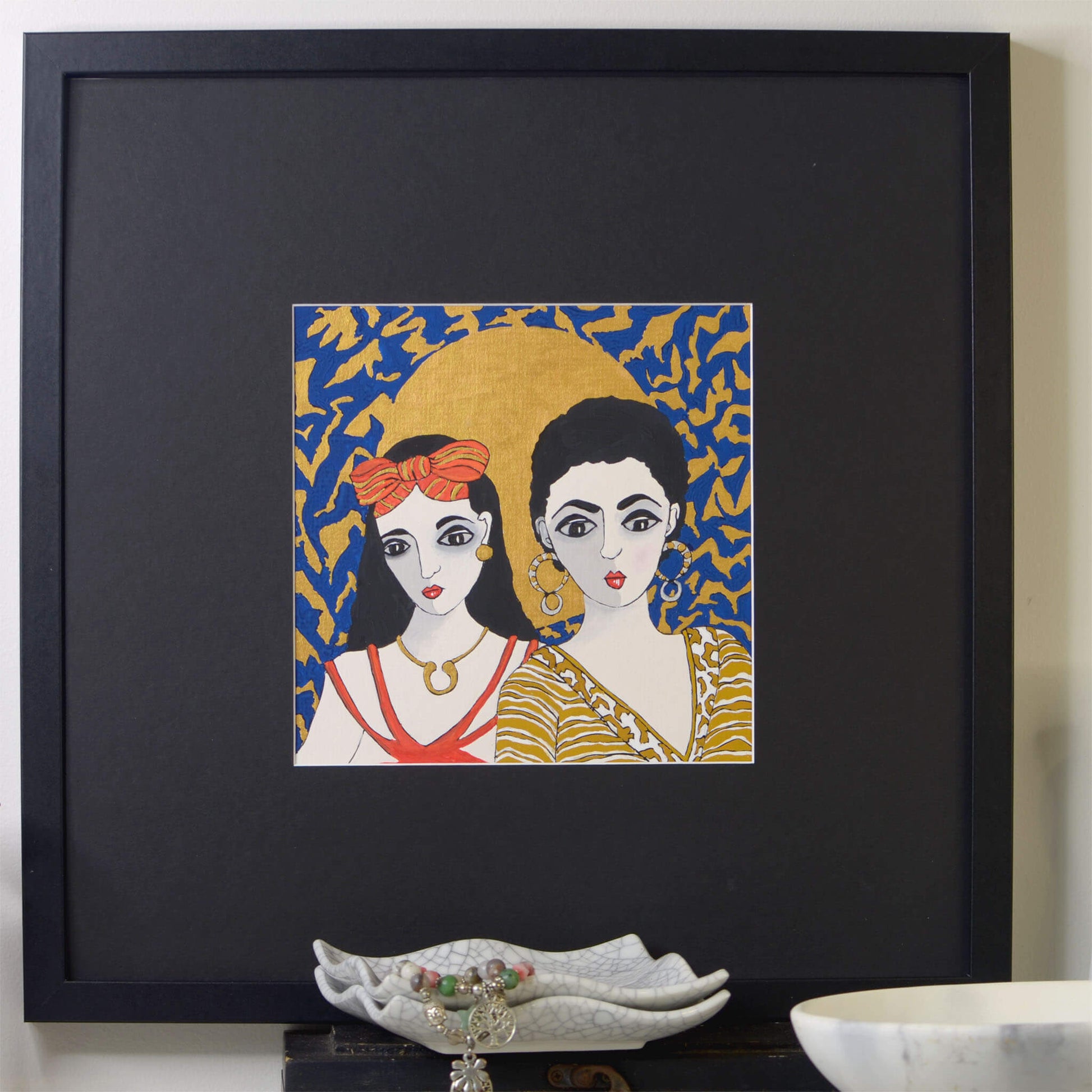 Small, original gouache painting of spiritual feminine power and beauty with golden detail by Ella Que Artist in black single mat