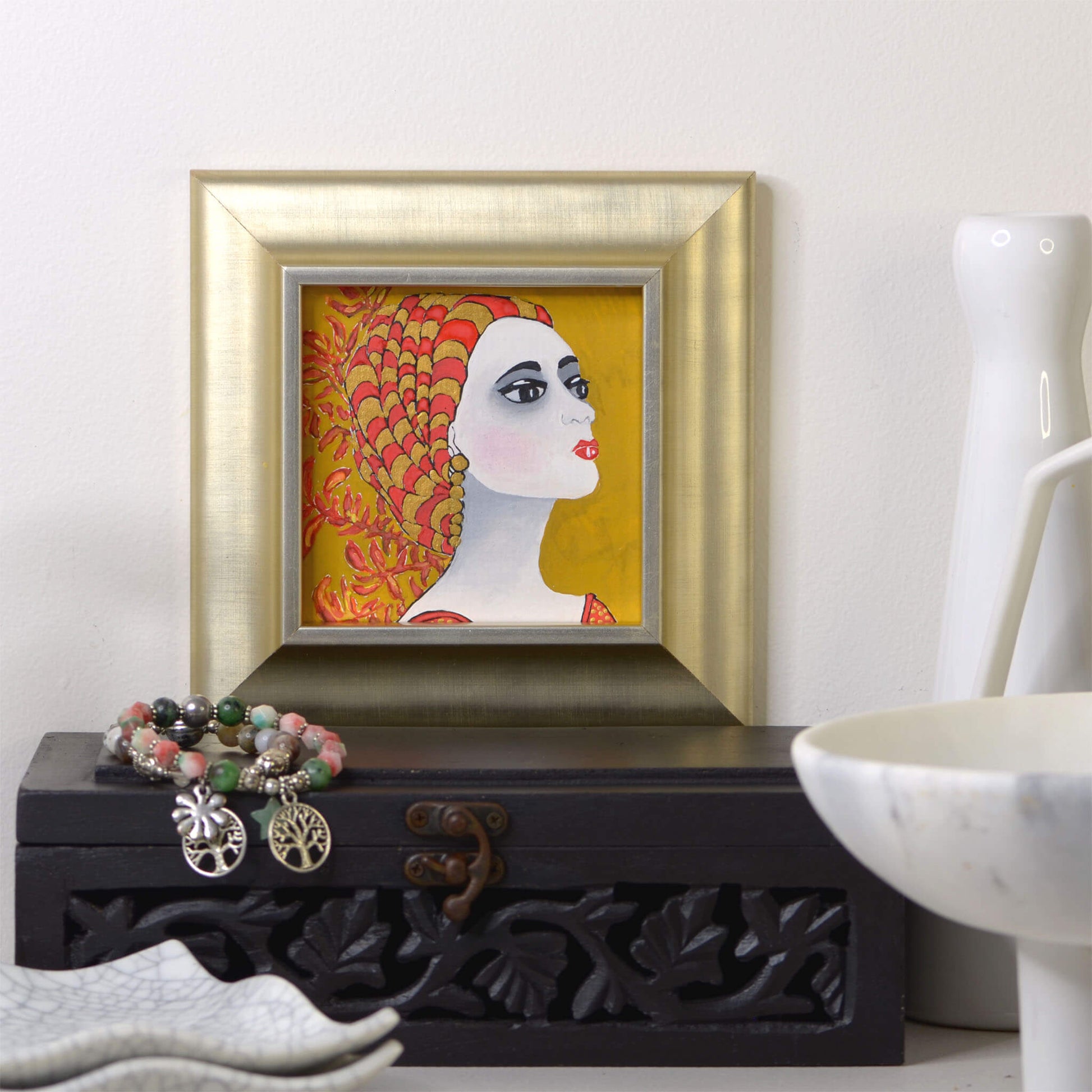 Tiny,  hand-painted original gouache painting of spiritual feminine power , kangaroo paw flowers and beauty with golden detail by Ella Que Artist in metallic picture frame