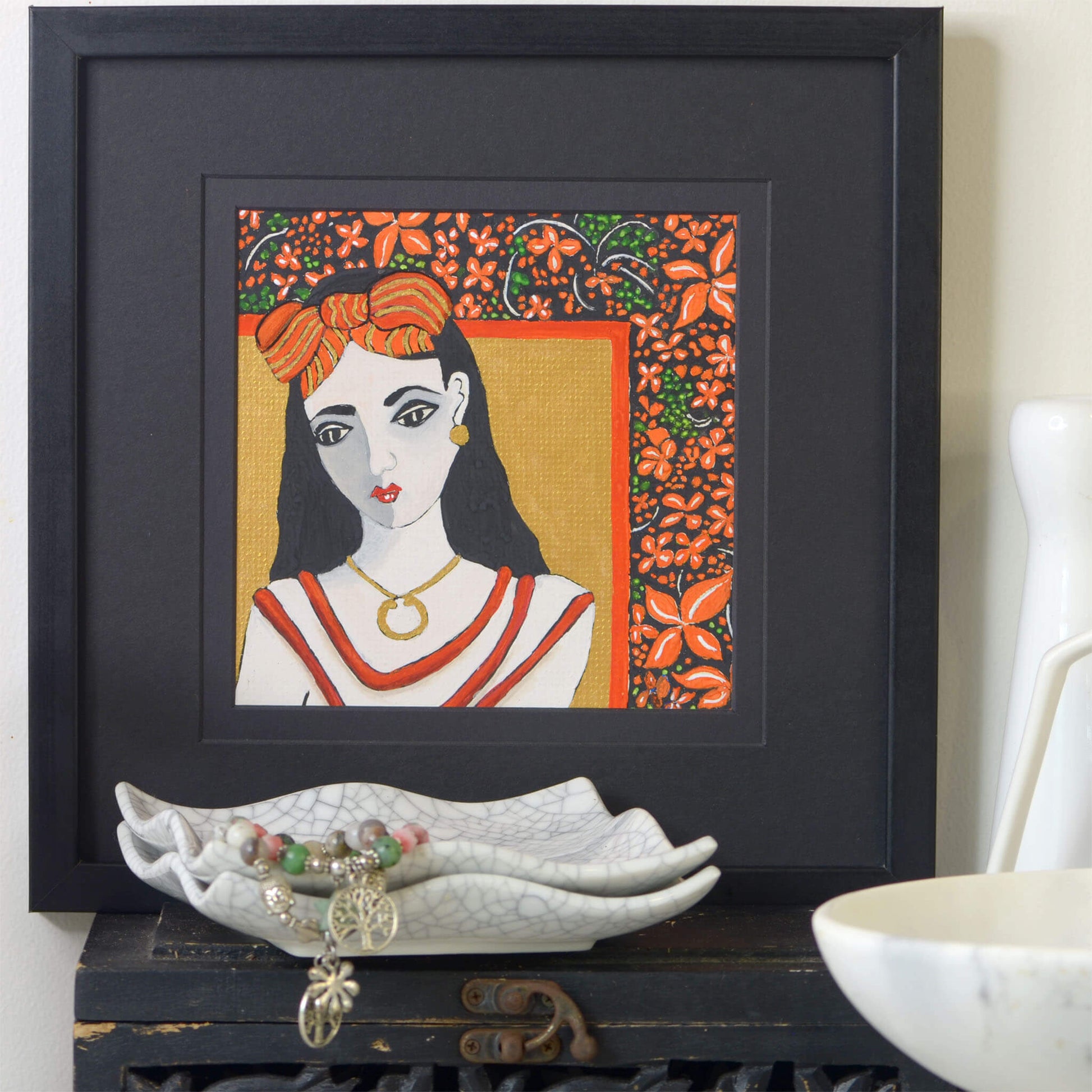 Small, hand-painted original gouache painting of spiritual feminine power , flowers and beauty with golden detail by Ella Que Artist in black single mat. The Sacred Flame